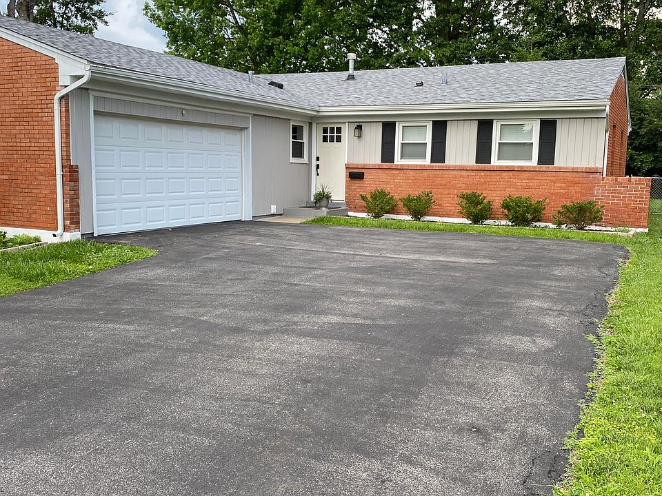 Front of house features 2-car attached garage and wide driveway.