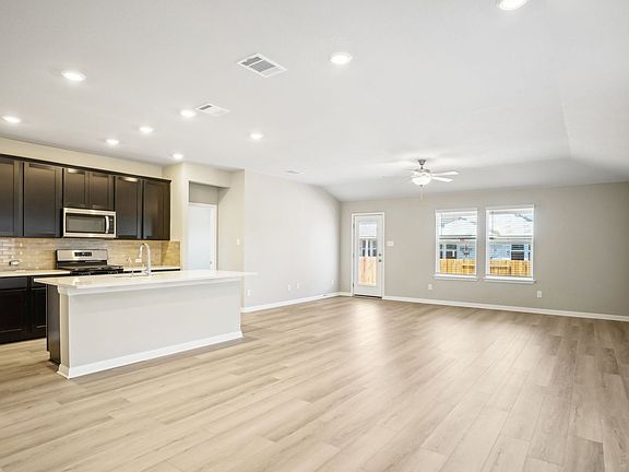 The open concept living, kitchen, and dining areas are great for entertaining.