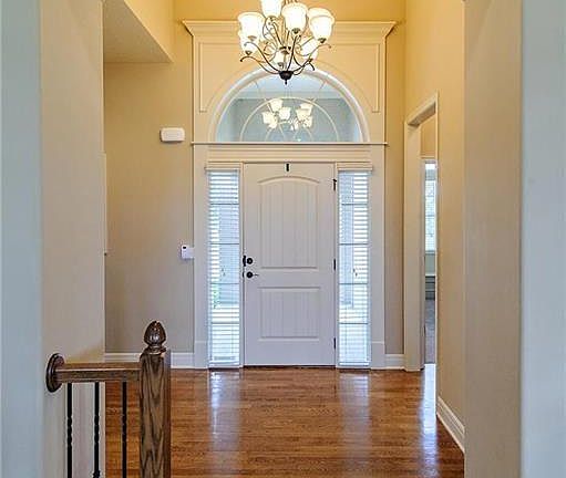 Arched doorways and gorgeous millwork exist throughout the home as well as wood floors and full window coverings (blinds).  There is a large closet in the entryway with plenty of room for coats, shoes, etc.