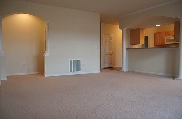 19x18 livingroom with book nook and wall to wall carpeting