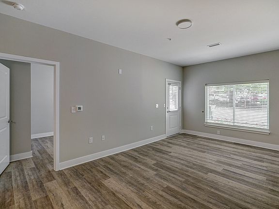 Living Room W/ Balcony Door & Secondary Room.