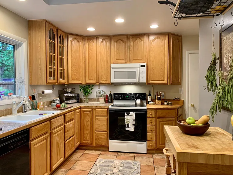 Kitchen with skylight and windows facing the yard
