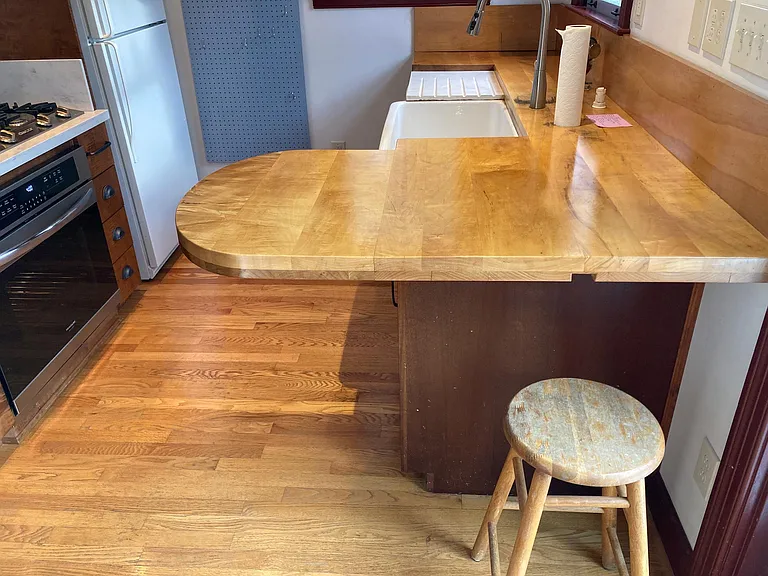 Kitchen counter also serves as a bar to pull up a stool.
