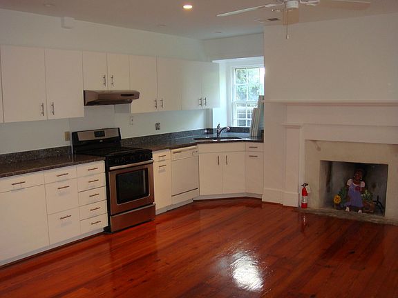 Kitchen with granite counter tops, dishwasher and stainless steel range.