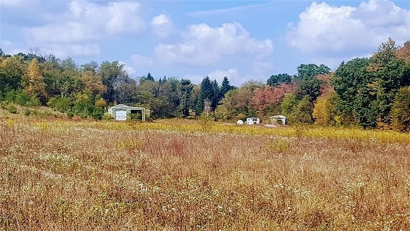 Looking toward the entrance to the property, there are several buildings and a weigh station. Three approximately 1 acre homesit