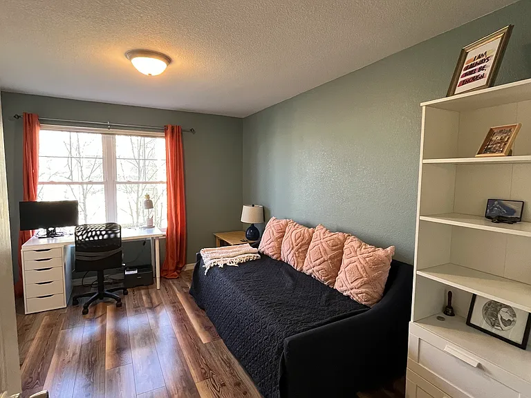 11 x 15 second bedroom/office space with a large built-in closet on the left.