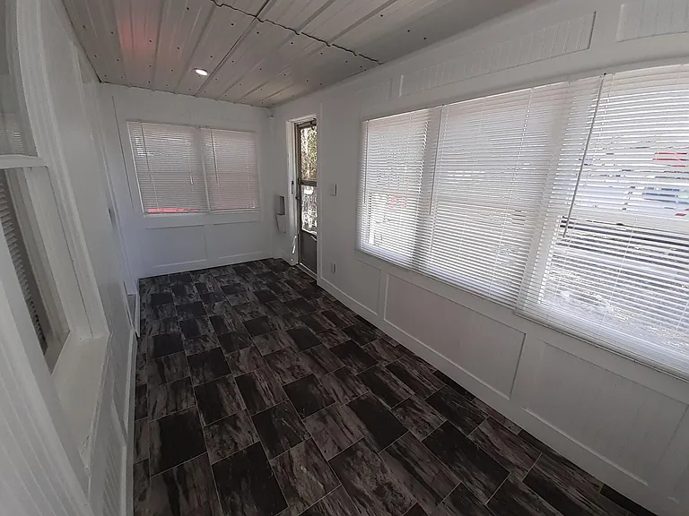 Bright enclosed Sunporch/Mudroom.
