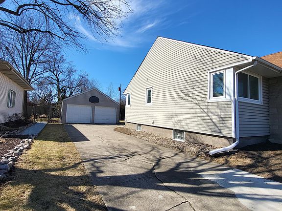 driveway to 2 car garage and basketball hoop