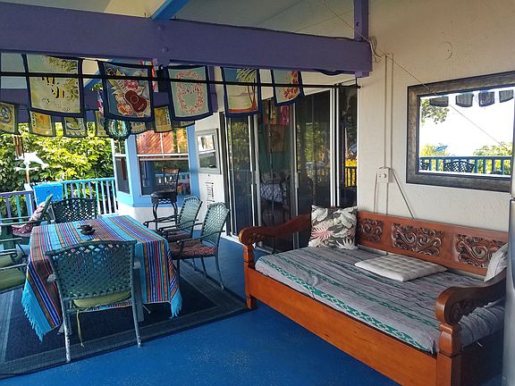 The lanai with a sofabed and dinner table.