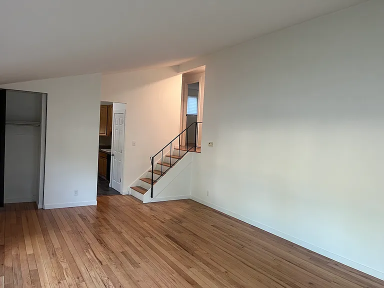 Main Floor living room- entrance to kitchen and 1/2 flight of stairs to upstairs hallway & bedrooms