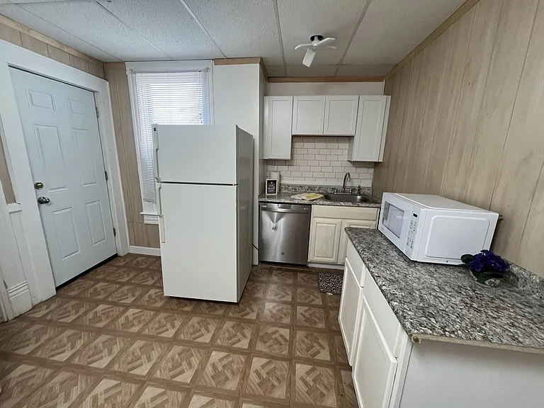 Fully-Equipped White Kitchen w/ Refrigerator, Stainless Steel Dishwasher & Gas Range/Oven & Microwave