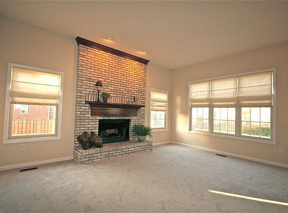 Large Family Room with gas fireplace with windows giving plenty light