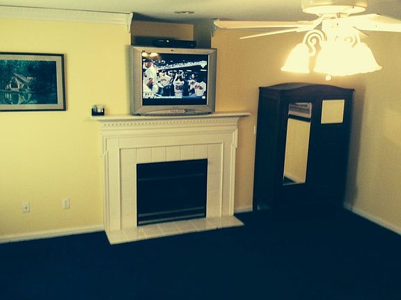 Comfortable Den
						:
						Space for family to gather around fireplace, watch television, or play games.