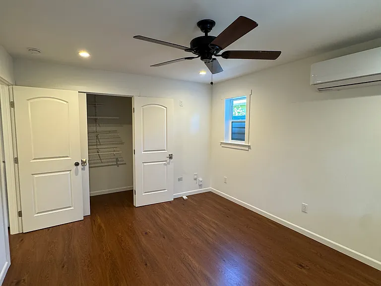 Bedroom with large closet, A/C cooling, fan