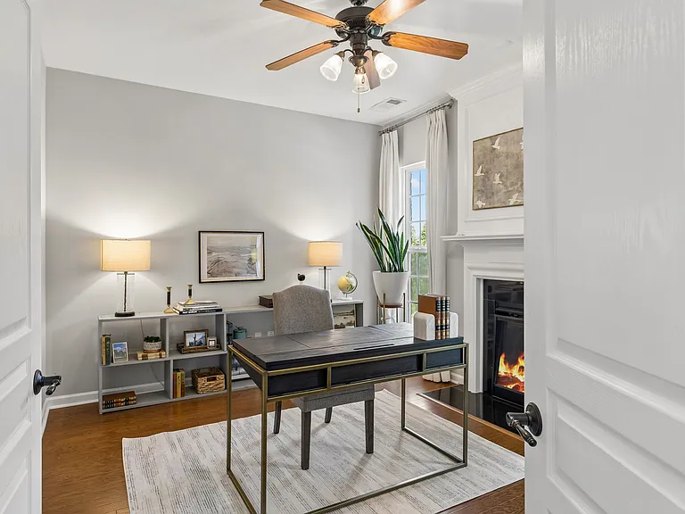 A rare and inviting feature, the private main-level study is anchored by a fireplace and framed by tall windows, offering a refined retreat for working from home, reading, or simply unwinding.