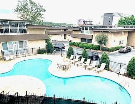 The balcony overlooks the pool, perfect for entertaining or just relaxing with friends while enjoying the crystal clear water and the outdoor grill.