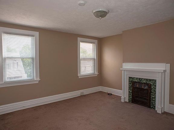 Large bedroom with decorative fireplace