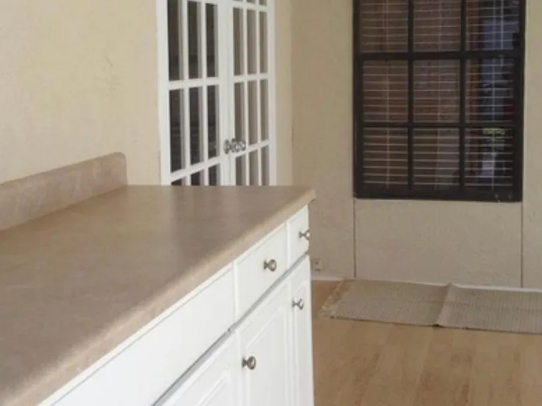 Storage or buffet area leading out to large screened patio.