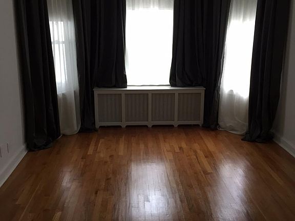 Living room space. The dark curtains are no longer hanging just nicer white curtains and shades.