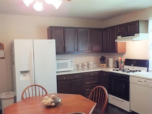 Eat-in kitchen has hardwood flooring, pantry and lots of cabinets