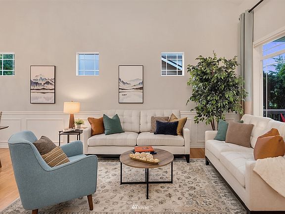 Living room is filled with natural light through large windows