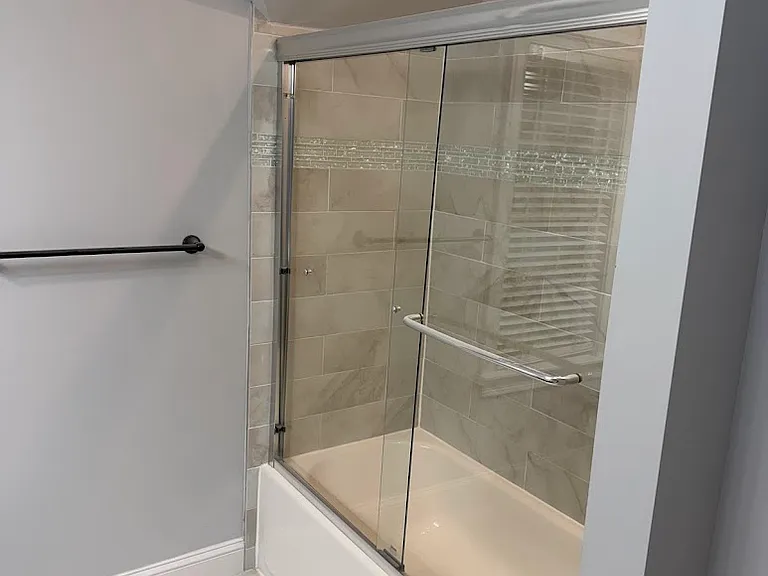 Primary bathroom with double sink vanity and shower/tub.