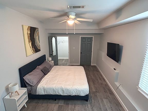 Bedroom has a walk-in closet and 50" TV