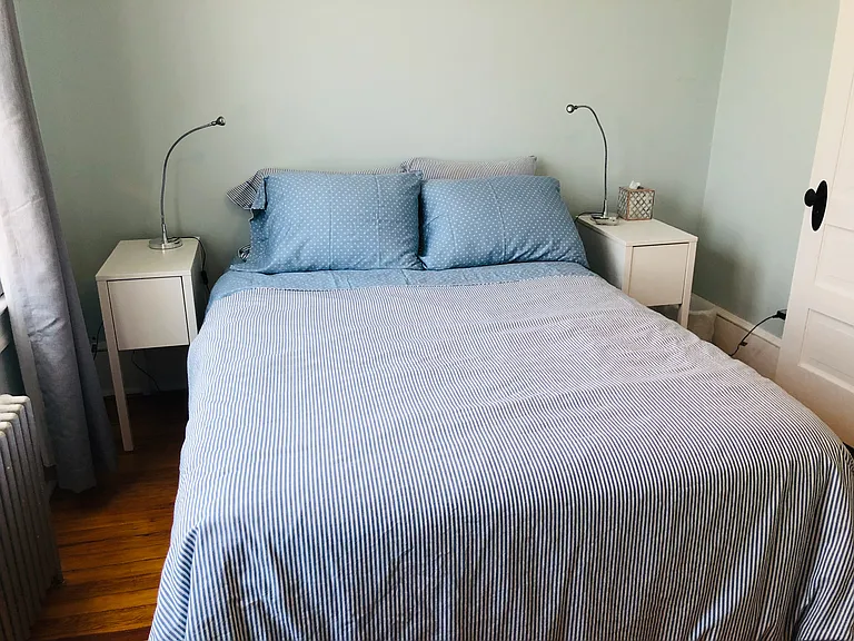 North facing back bedroom. Full size bed, 2 bedside tables, lovely vintage dresser, easy chair, ceiling fan, closet