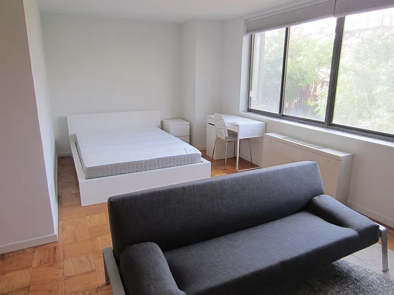 Sleeping area with Queen bed, night stand, desk & chair