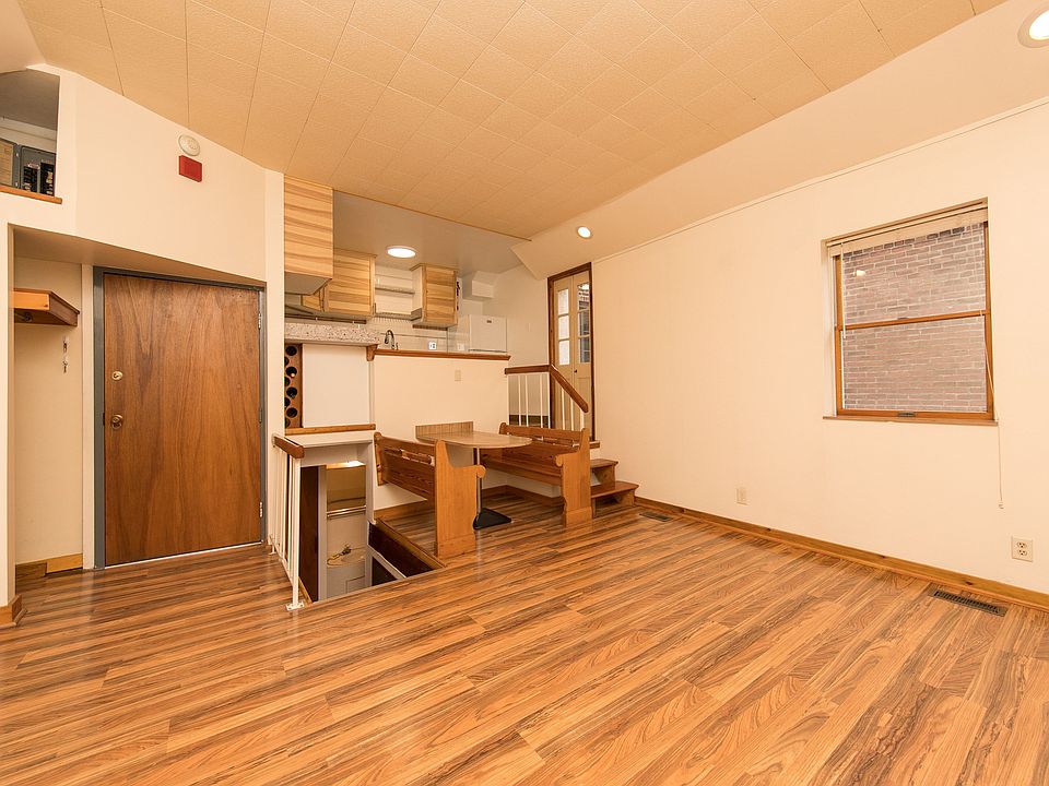 Living room shows entrance, coat closet & storage, bathroom lower level, booth, steps to kitchen