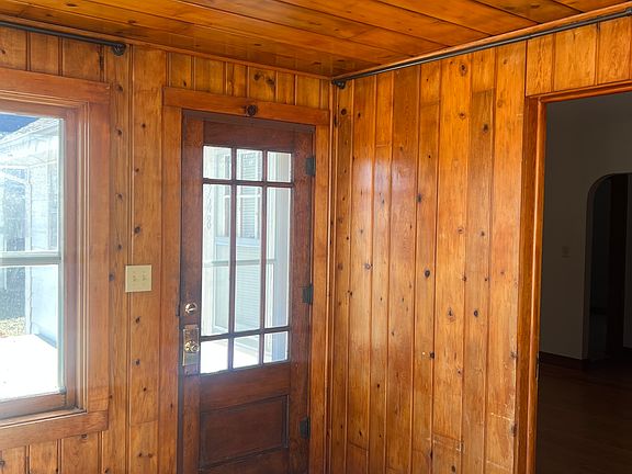 Front entry-cedar paneled enclosed porch area.