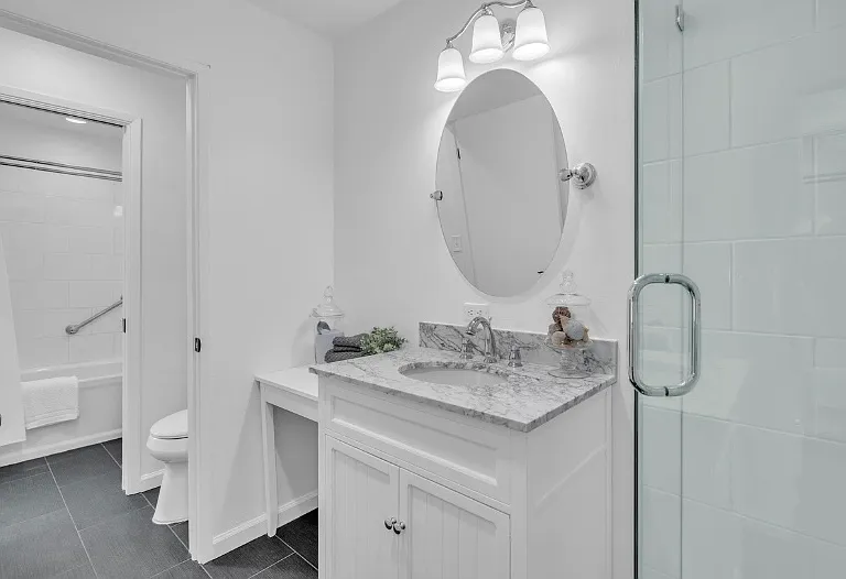 Second upstairs bathroom with shower and vanity and shared "jack/jill" toilet.