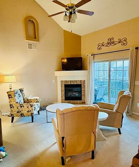 Living Space with tall 25 ft ceiling and gas fireplace