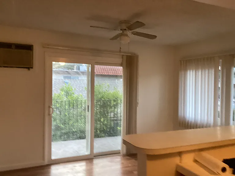 Dining area with ceiling fan. Sliding glass doors to pation. Counter/bar or entertaining.