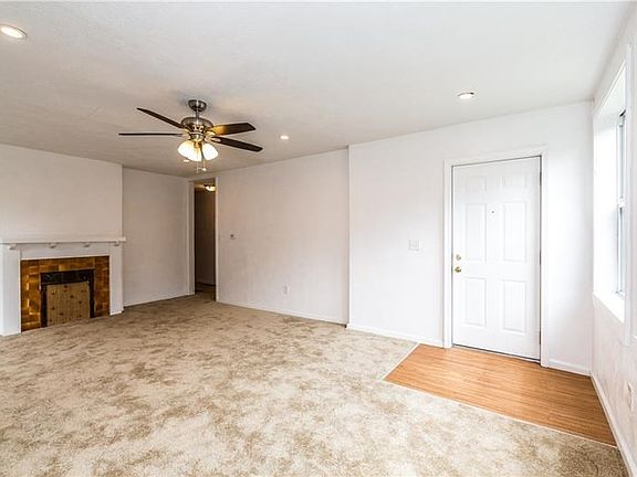 Apartment one living room with recessed lighting and new flooring.