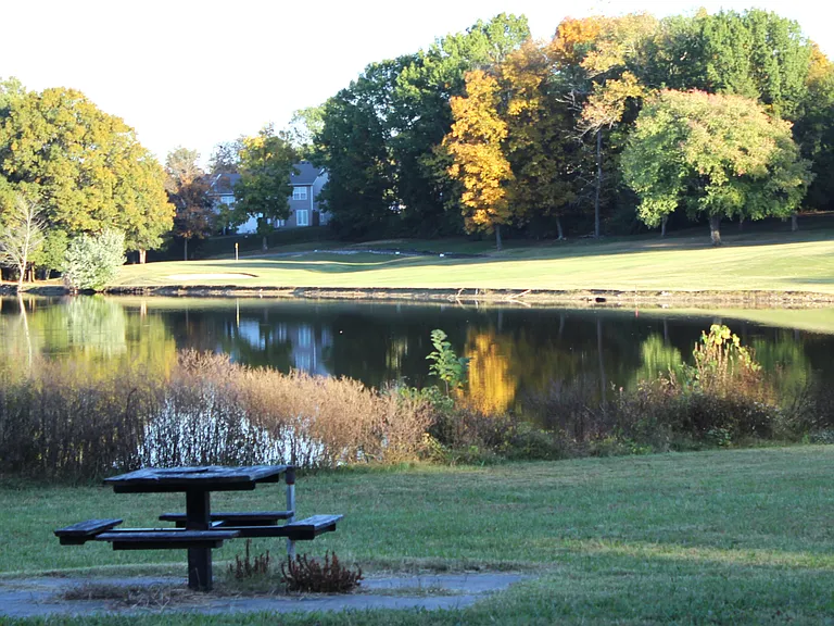 Beautiful Pond and picnic table area in the Golf Community Property Neighborhood. Walkable on the sidewalks