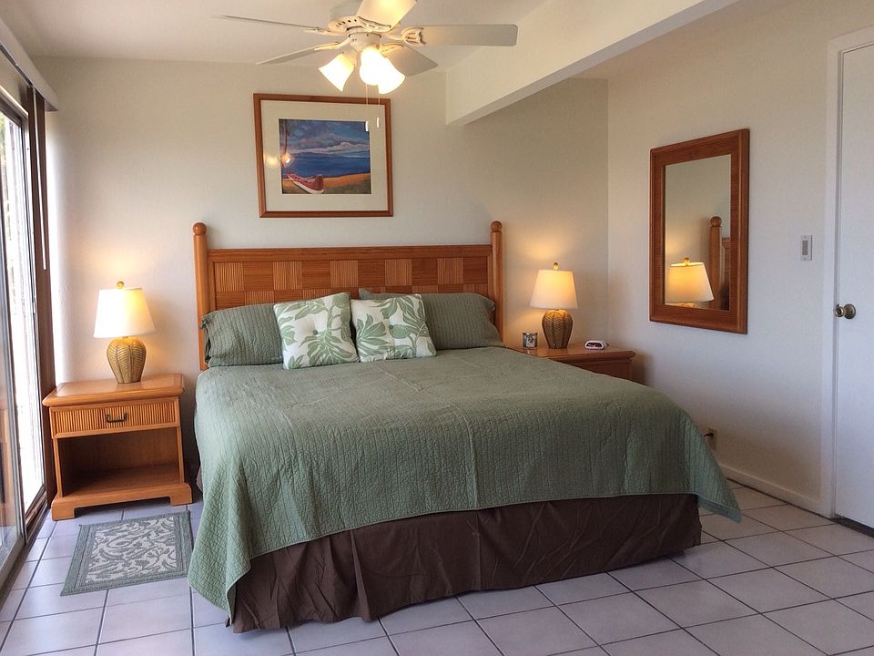 The master bedroom features a king size bed and a sliding do