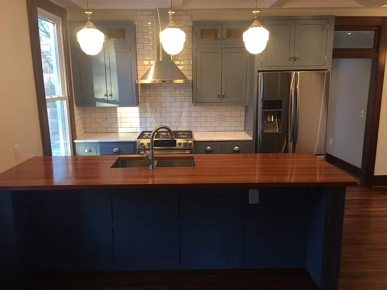 looking at the kitchen from the family room, with the powerful commercial gas range you need the beautiful hood