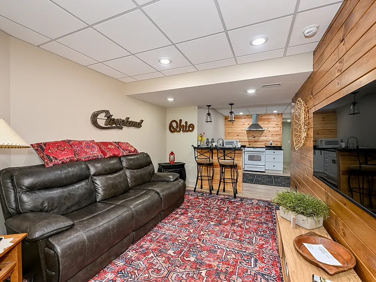 The living room welcomes you to Northeast Ohio, complete with a gas stove for those cold weather nights! 45" TV for local channels with entertainment channels available.