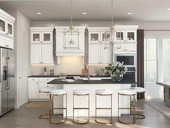 Kitchen with pendant lights vast island