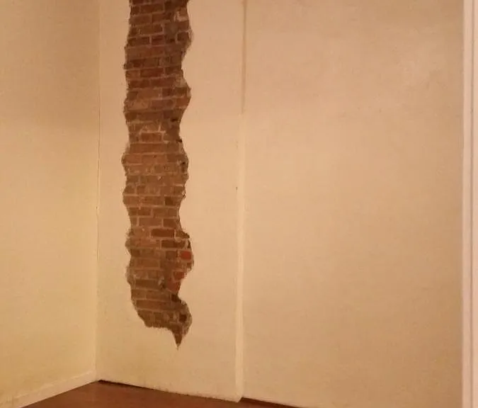 Exposed French Quarter Brick wall in Master Bedroom