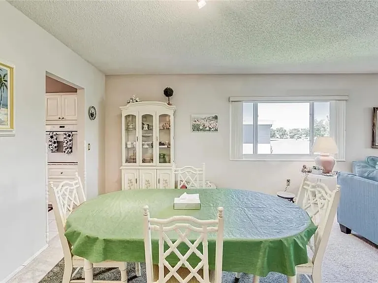 Dining area. The window faces west with a view of the golf course. 

 *This unit is unfurnished. All furniture has been removed.