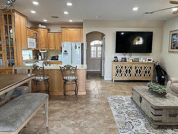 great room on first floor, clean kitchen, tile floors, 65" Sony Bravia tv with direct tv cable pkg, ten foot ceilings, tile floors, access to back deck and boat lift.