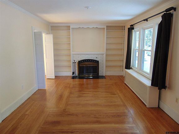 Refinished hardwood floor, fireplace, built-ins, opens to dining room, measures 19' 7" x 10' 8"