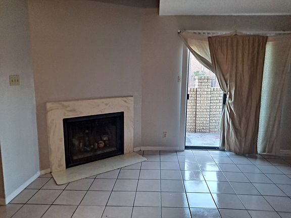 Living/Dining Room with working chimney & tile flooring throughout