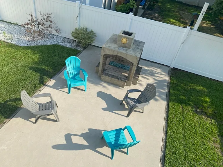 Large, grassy backyard with fire pit