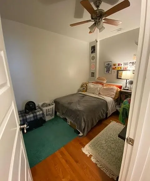 Bedroom two with ceiling fan, hardwoods.