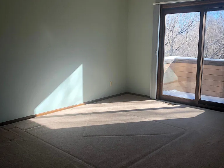 Primary bedroom with sliding door to balcony