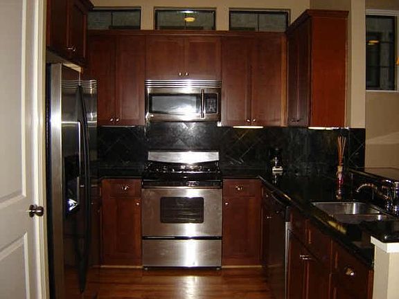 Stainless appl.(frig stays), granite ctrs, brkfst bar, w/door to 2-car garage.