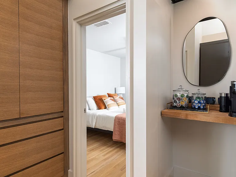 Primary bedroom with king bed, attached bathroom and ceiling fan.